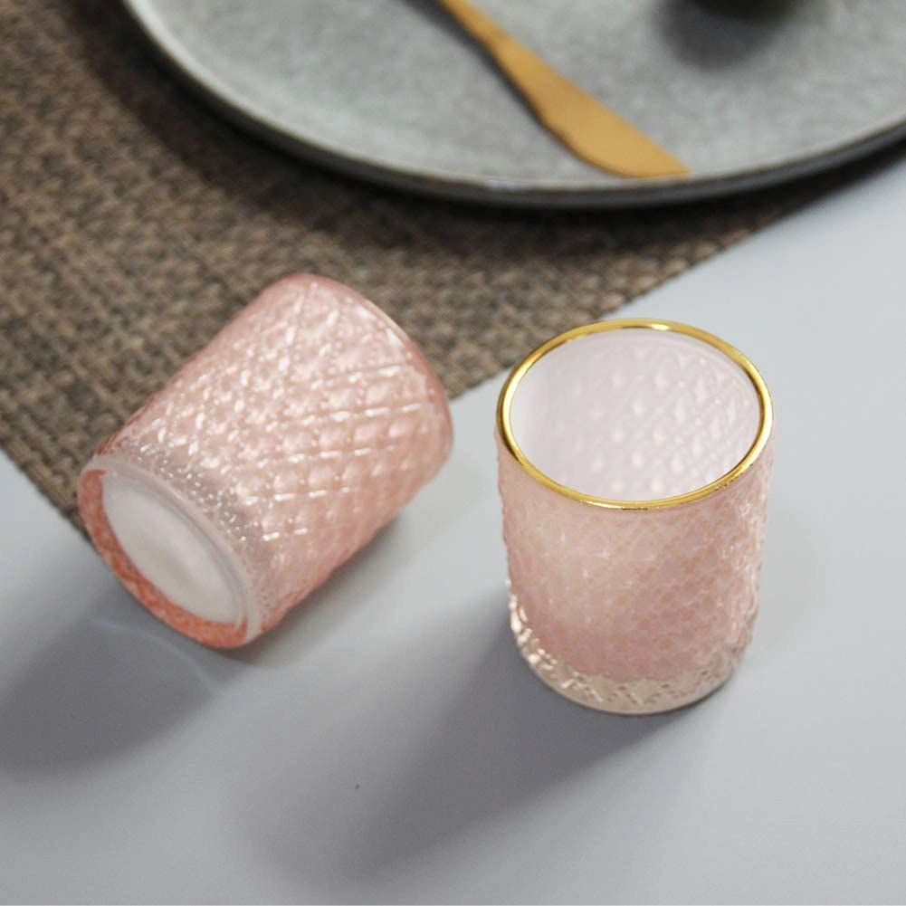 Pink textured glass cups on table