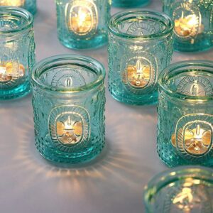 Decorative teal jars with candles lit