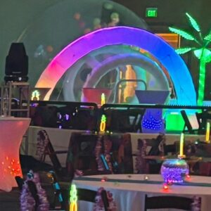 Neon lights illuminate party tables and decor