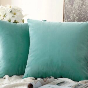 Teal cushions on a cozy sofa