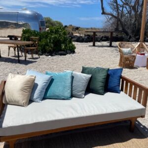 Vintage trailer and wicker chairs on beach