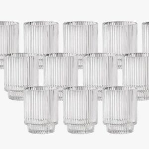 Glass candle holders arranged in a triangle