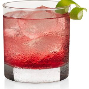 Red cocktail with ice and lime twist.