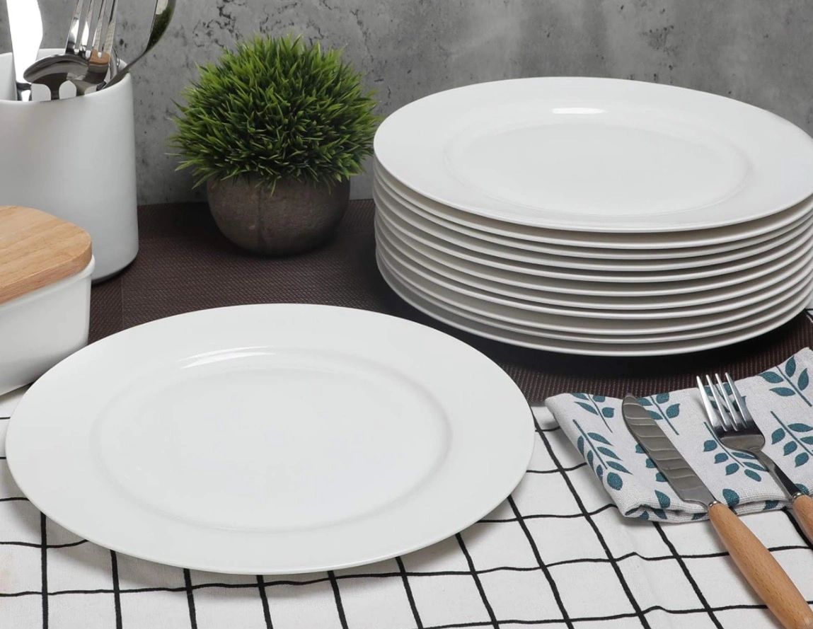 Stacked white plates on a kitchen counter