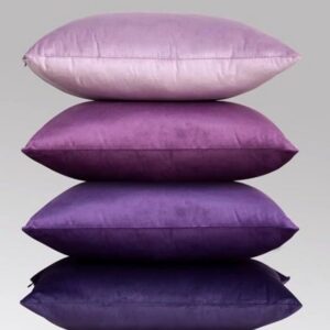 Stacked purple pillows on gray background