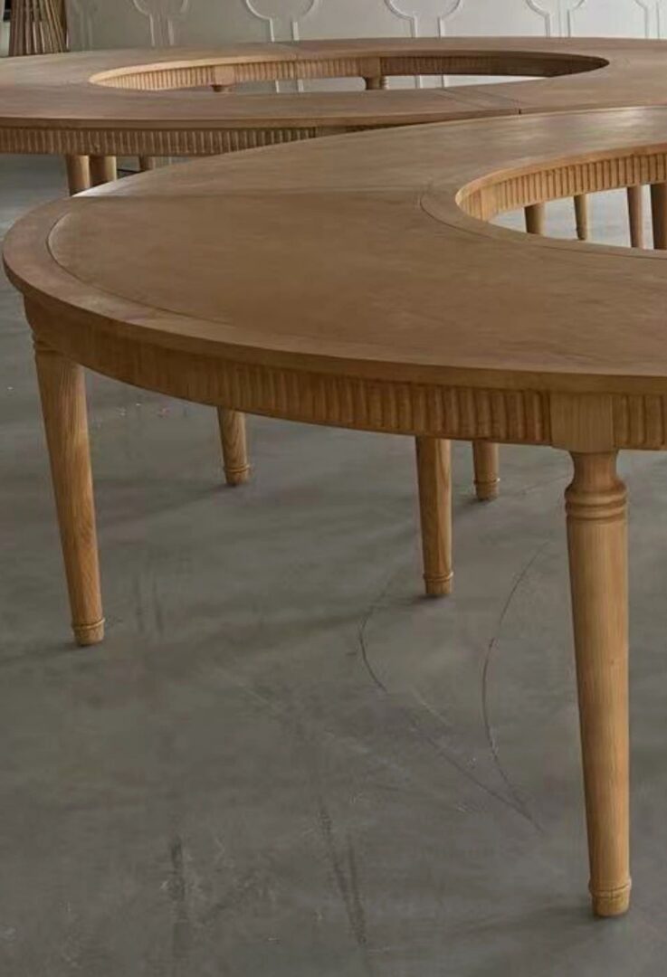 Curved wooden tables with elegant legs