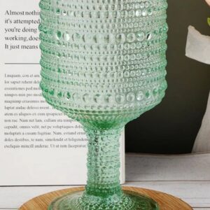 Green textured glass goblet on table