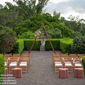 Outdoor wedding ceremony setup with wooden chairs