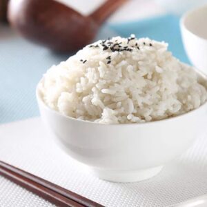 Bowl of rice with chopsticks nearby