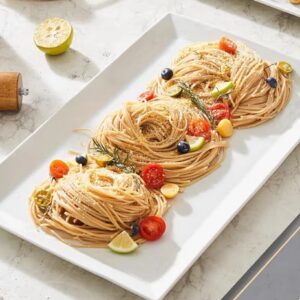 Elegant pasta presentation on white platter