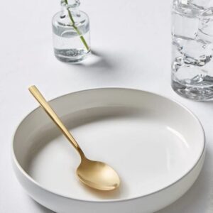 Minimalist dining arrangement with gold spoon