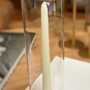 Glass candle holder with white candle