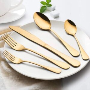 Gold cutlery set on white plate
