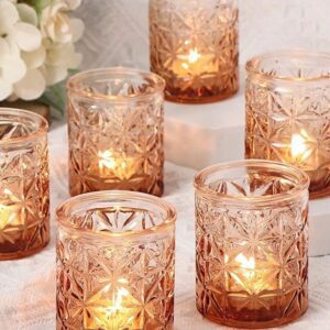 Glowing candles in decorative glass holders