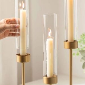 Hand adjusting a tall candle holder