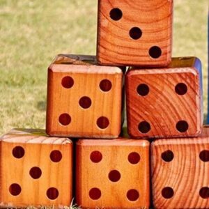 Wooden dice stacked on grass